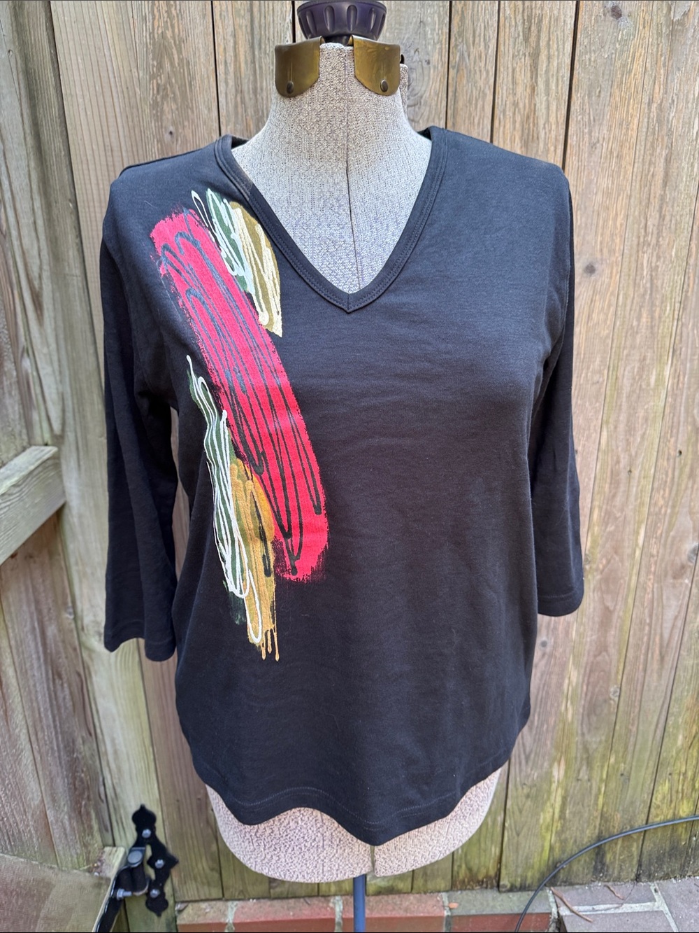 Victorias Black V-Neck Long Sleeve Tee with Red and Gold Brushstroke Accent